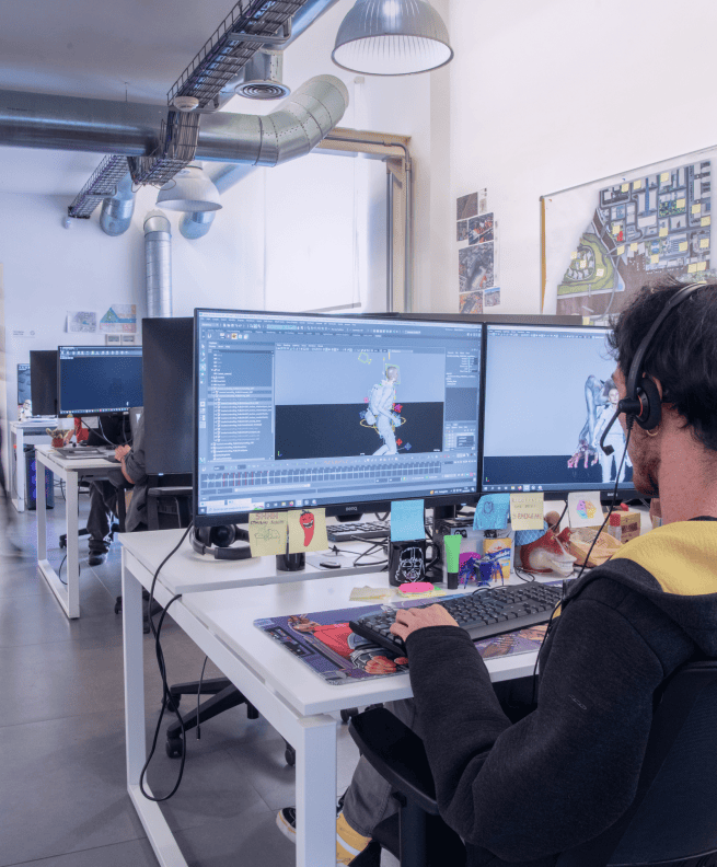 A team member working on 3D animation software at a desk in a modern office space. A team member working on 3D animation software at a desk in a modern office space.