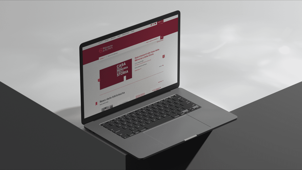 A laptop displaying the Biblioteche di Roma website with a focus on the homepage design.