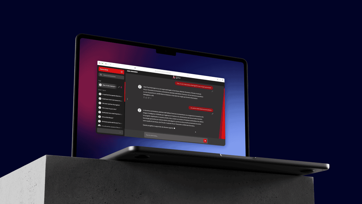 A laptop showcasing the AMA Gramsci AI interface on a concrete platform.